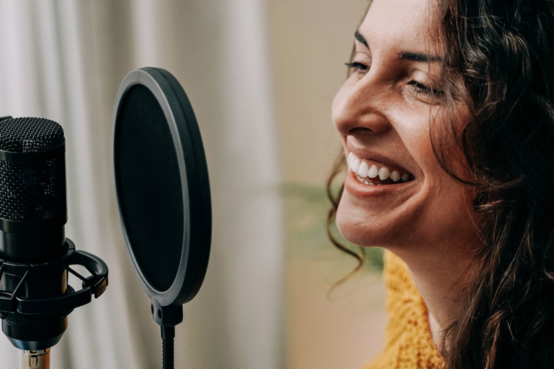 a woman speaking to a microphone to change her voice in realtime with ai