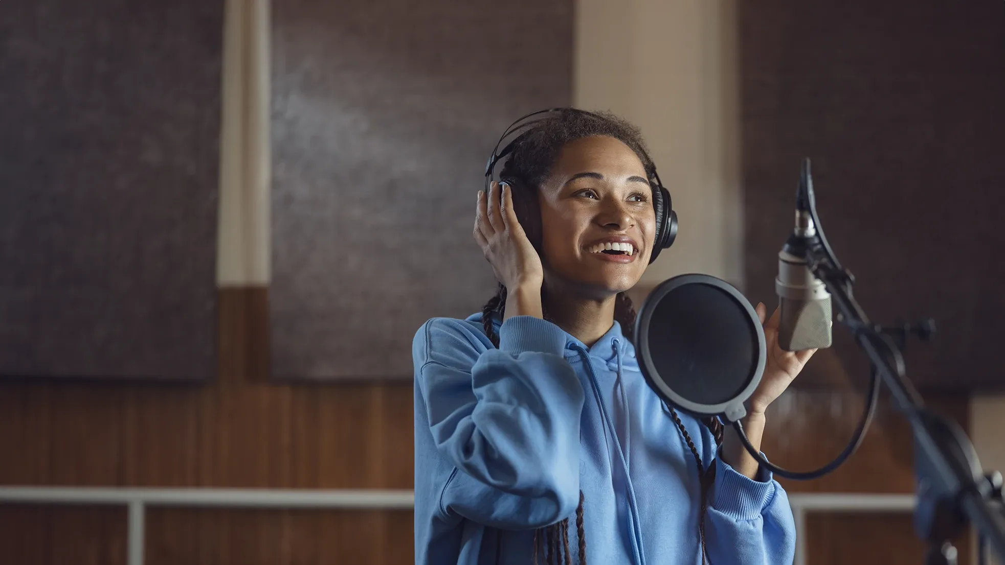 Woman recording her voice in a professional recording studio setting