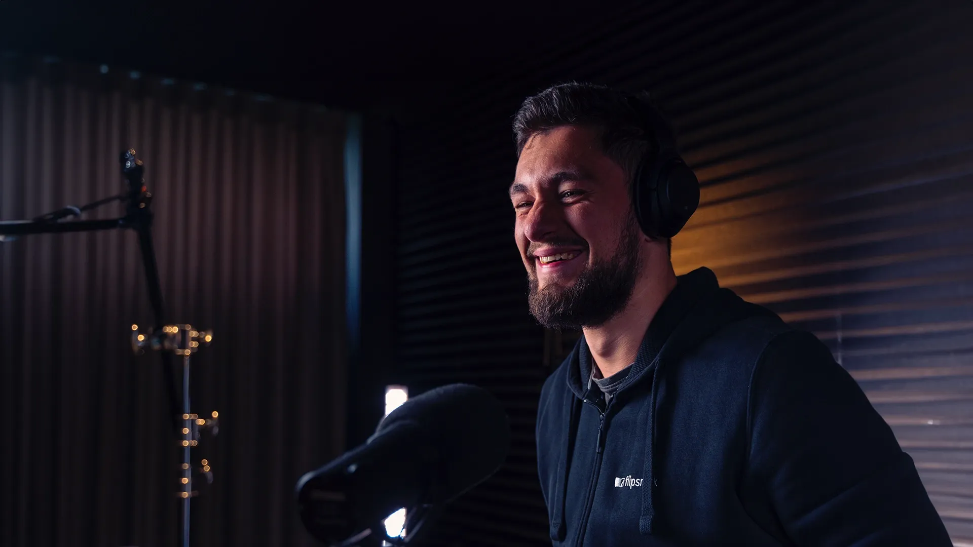 A man recording his voice in front of a microphone for an influencer program